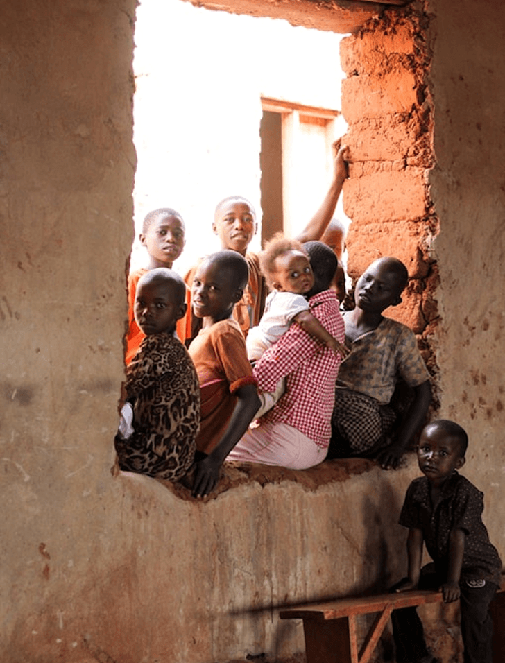 Community and children indoors at an A'khira Charity program gathering