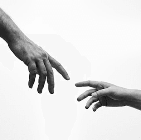 Two hands reaching toward each other in a black-and-white symbolic photo of giving