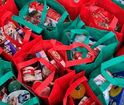 Packed grocery bags and staple food packages ready for family distribution